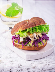 Burger with avocado, white meat grilled chicken, red cabbage, lisityami fresh green salad