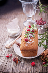 Homemade cupcake cake with cranberries and rosemary on a wooden background