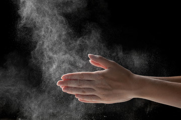 Fototapeta na wymiar woman coating her hands in powder chalk magnesium