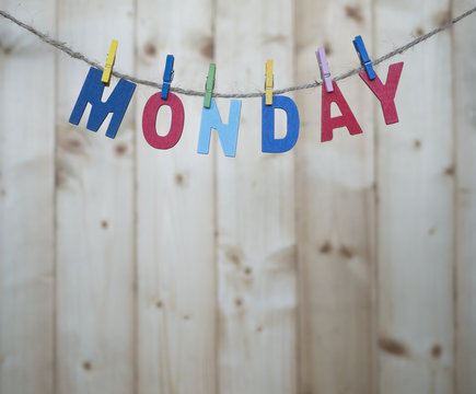 Weekdays 2 - Monday word by wooden letters hang with rope on wood background (Weekdays word series)