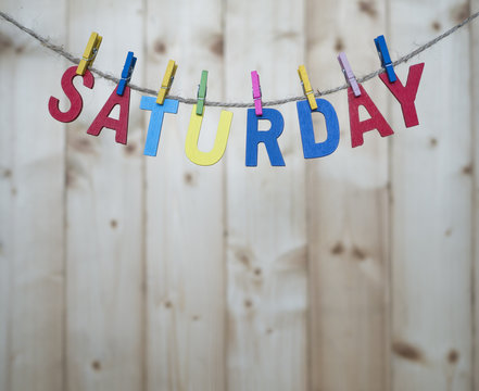 Weekdays 7 - Saturday word by wooden letters hang with rope on wood background (Weekdays word series)