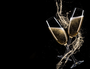Glasses of champagne with splash, celebration theme. - obrazy, fototapety, plakaty