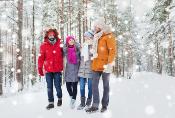Fototapeta na wymiar group of smiling men and women in winter forest