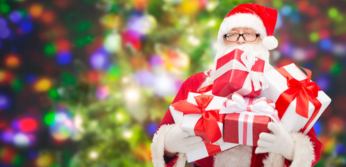 man in costume of santa claus with gift boxes