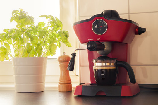 A Red Vintage Looking Espresso Coffee Machine In Kitchen
