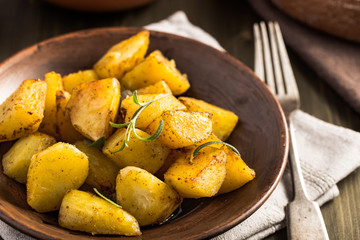 Baked potato with rosemary on plate