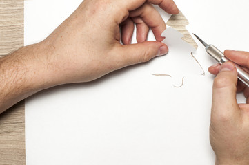 Cutting the New Year tree out of paper.