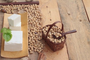 Fototapeta premium Tofu and soybeans on wood background.