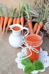 Fresh squeezed carrot juice and fresh carrots.