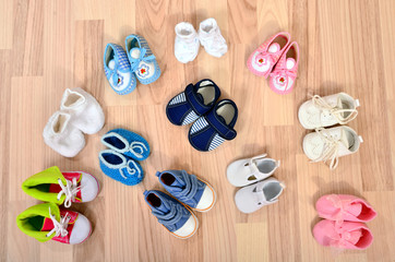 Baby shoes arranged on the floor. Tidy tiny child boots nicely arranged.