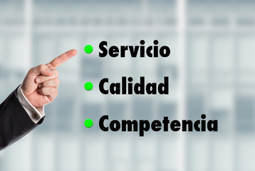 Business man pointing at the words, Service-Quality-Competence