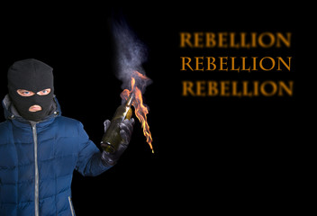 A man in a mask balaclava with a lit Molotov cocktail. isolated