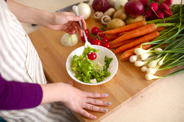 Young Woman Cooking in the kitchen. Healthy Food
