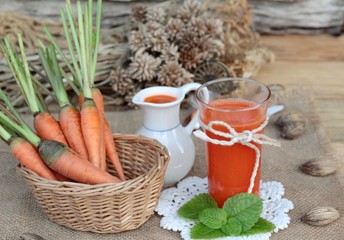 Fresh squeezed carrot juice and fresh carrots.