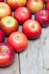 Red apples on wooden board.