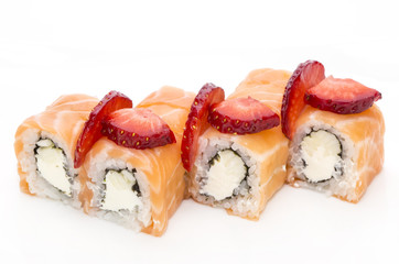 plate of sushi beautifully decorated with salad and fruit on a white background