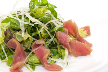 salad of arugula and tuna vegetables on a white background in the restaurant