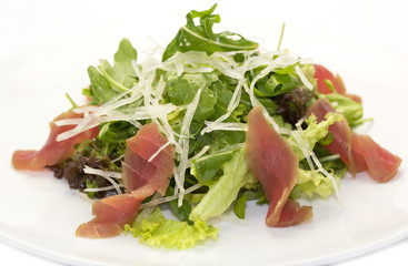 salad of arugula and tuna vegetables on a white background in the restaurant