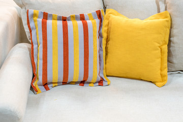 colorful pillows on grey sofa