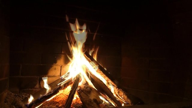 frontal image of fireplace and wood burning
