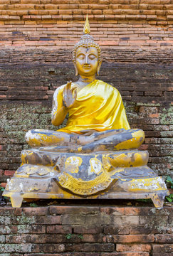 Old imgae of buddha on the chedi in public temple