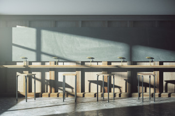 Old style university classroom with furniture and blackboard at