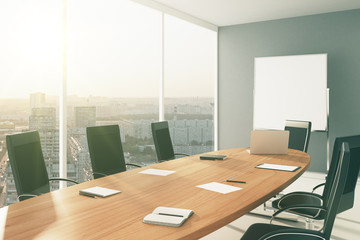 Light conference room with furniture, blackboard and city view