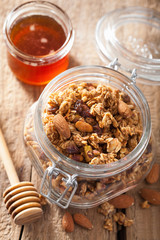 homemade healthy granola in glass jar and honey