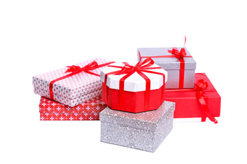 Gift boxes with xmas presents wrapped in red paper with ornament, isolated on white background