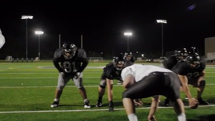 A football player tackles his opponent and another player dives on the ball
 - Powered by Adobe