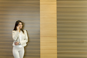 Young woman with mobile phone in the office