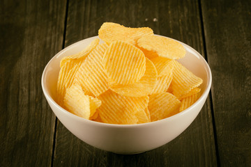 potato chips on wood - soft focus with vintage film filter