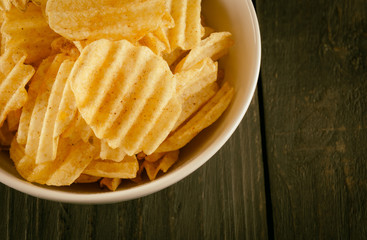 potato chips on wood - soft focus with vintage film filter
