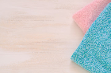 Obraz na płótnie Canvas Stack of bath towels on light wooden background closeup