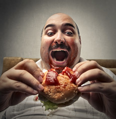 Hungry man eating a hamburger 
