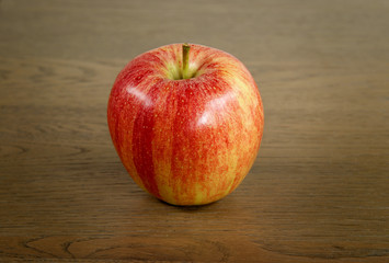 red apple on a wooden substrate
