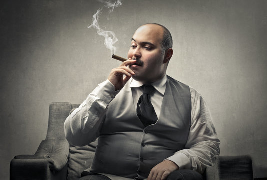 Fat man smoking a cigar
