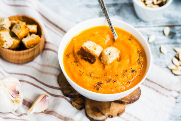 Pumpkin soup with carrots, croutons in a white dish