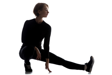 Slim woman doing one-legged squat