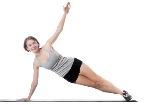 Sporty woman doing side plank exercise