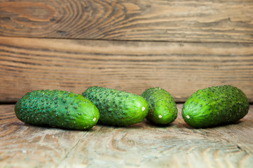 Group of green cucumbers on the wood table