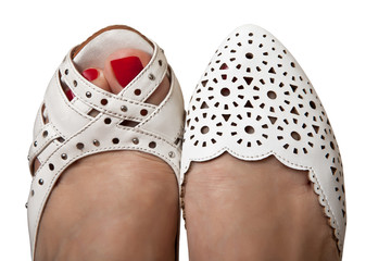 Women's feet in summer shoes white