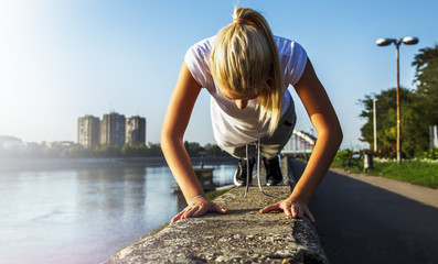 Sports girl doing push ups