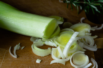 Chopped, sliced leek on wooden chopping board