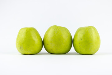 Three green apples on a white background