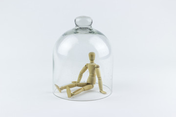 Wooden puppet in a glass bell