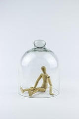 Wooden puppet in a glass bell