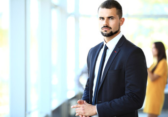 Image of smart young businessmen looking at camera at meeting