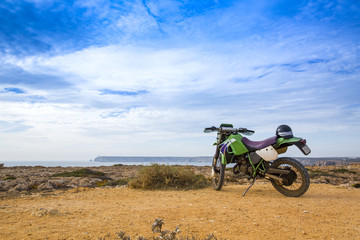 enduro motorcycle on the rock in Sagres, Portugal