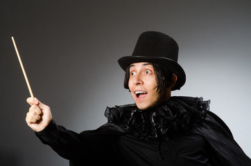 Funny magician wearing cylinder hat
